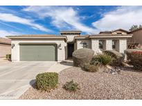 Single story home featuring a 2-car garage and desert landscaping at 21919 N Bradford Dr, Maricopa, AZ 85138