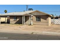 Traditional home featuring a brick exterior, simple landscaping, and a covered entryway at 2201 N 35Th Dr, Phoenix, AZ 85009