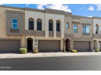 Modern townhome showcasing a neutral color scheme, attached garages, and well-maintained landscaping at 23065 N 75Th St, Scottsdale, AZ 85255