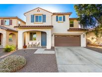 Charming two-story home boasts a covered entryway, two-car garage, and xeriscaped front yard at 26312 N 132Nd Ln, Peoria, AZ 85383