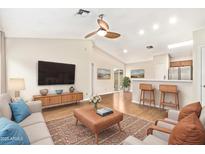 Bright, airy living room boasts an open floor plan, ceiling fan, and wood-look floors for a modern, comfortable feel at 3147 E Michigan Ave, Phoenix, AZ 85032