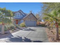 Charming home featuring desert landscaping, a stone facade, and a two-car garage at 3553 N 292Nd Dr, Buckeye, AZ 85396