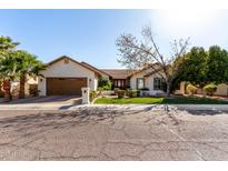 Charming single-story home with stucco siding, lush landscaping, and a two-car garage at 4217 E Edgemont Ave, Phoenix, AZ 85008