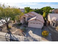 Charming single Gathering home featuring a desert landscape, a tile roof, and a two car garage at 4741 W Kristal Way --, Glendale, AZ 85308