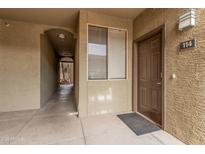 View of the exterior entrance to unit 114 with a textured wall and walkway at 5303 N 7Th St # 114, Phoenix, AZ 85014