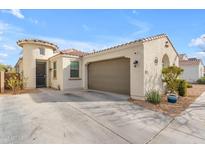 Charming home showcasing a two-car garage, turret entry and low maintenance desert landscaping at 5637 S 29Th Pl, Phoenix, AZ 85040