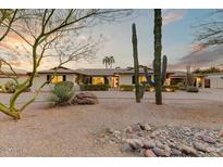 Charming home featuring desert landscaping, including mature cacti and boulder accents at 6323 E Gold Dust Ave, Paradise Valley, AZ 85253