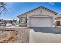 Charming single-story home with a two car garage and desert landscaping at 6557 W Puget Ave, Glendale, AZ 85302