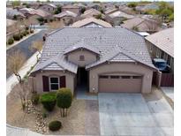 Charming single-story home featuring a well-maintained front yard and a two-car garage at 7609 W Whitehorn Trl, Peoria, AZ 85383