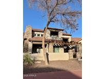 Charming two-story home with stone accents, a pergola-covered porch, and desert landscaping at 804 W Village Pkwy, Litchfield Park, AZ 85340