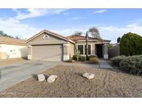 Charming single-story home with a well-maintained yard and attached two-car garage at 8434 E Natal Cir, Mesa, AZ 85209