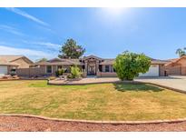 Charming single-story home featuring a well-manicured lawn and desert landscaping at 8621 W Via Montoya Dr, Peoria, AZ 85383