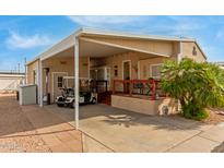 Charming home featuring covered parking, a covered porch, and well-maintained landscaping at 8700 E University Dr # 2674, Mesa, AZ 85207