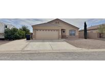 Charming single-story home featuring a two-car garage and low maintenance landscaping at 10323 W Carousel Dr, Arizona City, AZ 85123