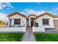 Charming single-story home featuring a well-manicured lawn and inviting front porch at 11307 E Ellis St, Mesa, AZ 85207