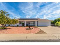 Charming single-story home featuring a brick circular driveway and solar panels at 13019 N 98Th Ave, Sun City, AZ 85351