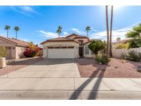 Charming single-story home featuring a two-car garage, desert landscaping, and mature palm trees at 15431 S 36Th Pl, Phoenix, AZ 85044