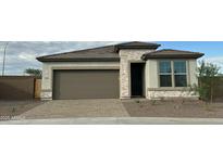 Charming single-story home featuring a two-car garage and stylish stone accents at 17916 W Puget Ave, Waddell, AZ 85355