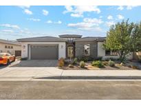 Beautiful home with stone accents, desert landscaping, and a two-car garage at 2081 E Aquarius Pl, Chandler, AZ 85249