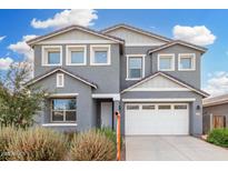 Two-story home with a gray exterior, white trim, a two-car garage, and desert landscaping under a partly cloudy blue sky at 22679 E Estrella Rd, Queen Creek, AZ 85142