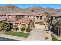 Charming two-story home with a well-manicured lawn, palm trees, and a mountain view at 2738 W Silver Fox Way, Phoenix, AZ 85045