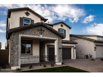 Charming two-story home with desert landscaping, brick accents, and an inviting front porch at 3646 E Roland St, Mesa, AZ 85215
