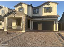 Charming two-story home featuring a brick driveway and a spacious two-car garage at 3646 E Roland St, Mesa, AZ 85215