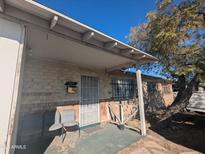 Inviting front porch area with chairs and brick facade under blue skies at 3932 W Bethany Home Rd, Phoenix, AZ 85019