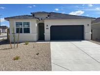 Charming single-story home with a two-car garage and neutral-colored exterior at 469 W Freedom St, Florence, AZ 85132