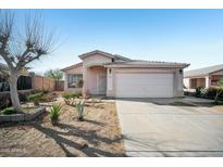 Charming single-story home with a tile roof, desert landscaping, and a two-car garage at 7557 W Colter St, Glendale, AZ 85303