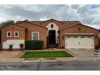 Charming single-story home featuring a well-maintained lawn, desert landscaping, and a two-car garage at , Gilbert, AZ 85234