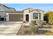 Charming single-story home with a two-car garage, neutral colors, and desert landscaping at 10064 E Tamery Ave, Mesa, AZ 85212