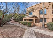 Inviting two-story condo featuring a private entrance and well-maintained landscaping at 14849 N Kings Way # 111, Fountain Hills, AZ 85268