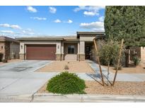 Inviting single-story home featuring a well-manicured yard, two-car garage, and neutral color scheme at 22924 E Desert Spoon Dr, Queen Creek, AZ 85142