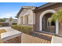 Charming front entrance with brick accents, arched gate and manicured landscaping at 253 W Malibu Dr, Chandler, AZ 85248