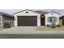 Charming single-story home with a brown garage door, blue accents, and desert landscaping at 35378 W Santa Barbara Ave, Maricopa, AZ 85138