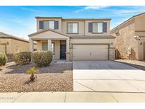 Charming two-story home with a two-car garage, neutral-colored facade, and low-maintenance landscaping at 38179 W La Paz St, Maricopa, AZ 85138