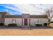 Charming townhouse featuring a distinctive maroon front door and well-maintained landscaping at 4857 N Granite Reef Rd, Scottsdale, AZ 85251