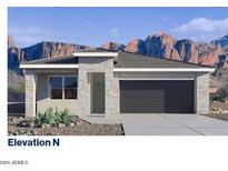 New construction exterior elevation with stone veneer and desert landscaping with mountain backdrop at 4939 S 105Th Dr, Tolleson, AZ 85353