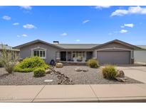 Charming single-story home showcasing a low maintenance front yard and attached two-car garage at 5061 E Edgewood Ave, Mesa, AZ 85206