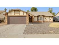 Charming single-story home with a brown garage door and low maintenance landscaping at 510 S Kenwood Ln, Chandler, AZ 85226