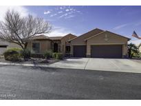 Charming single-story home featuring a three-car garage, tile roof and desert landscaping at 5450 N Globe Dr, Eloy, AZ 85131