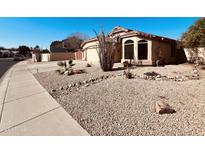 Charming single-story home with desert landscaping, spacious driveway and two car garage at 6458 W Adobe Dr, Glendale, AZ 85308