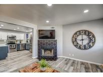 Spacious living area connected to kitchen with a decorative fireplace and vinyl floors at 901 W Parkway Blvd, Tempe, AZ 85281