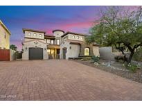 Beautiful stucco home with a large brick driveway and two car garage, surrounded by mature landscaping at 10829 N 11Th Pl, Phoenix, AZ 85020