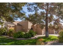 Charming home featuring a lush front yard with mature trees and manicured landscaping at 14003 W Cavalcade Dr, Sun City West, AZ 85375
