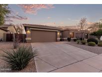 Inviting single-Gathering home with a well-manicured yard, desert landscaping, and two car garage at 17857 W Desert View Ln, Goodyear, AZ 85338