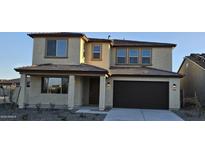 Two-story home featuring a neutral-toned exterior, covered entry, and two-car garage at 19201 W Missouri Ave, Litchfield Park, AZ 85340