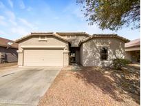 Charming single-story home featuring a well-manicured front yard and a two-car garage at 2014 E Connemara Dr, San Tan Valley, AZ 85140
