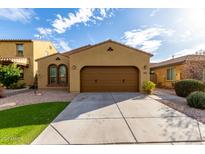 Charming single-story home featuring a two-car garage, desert landscaping and a welcoming facade at 227 E Carob Dr, Chandler, AZ 85286